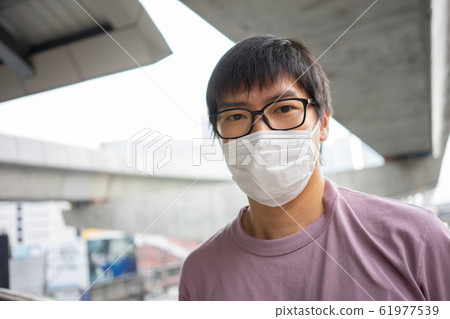 HandsomeMan wearing face mask protect filter HandsomeMan wearing face mask protect filter 61977539