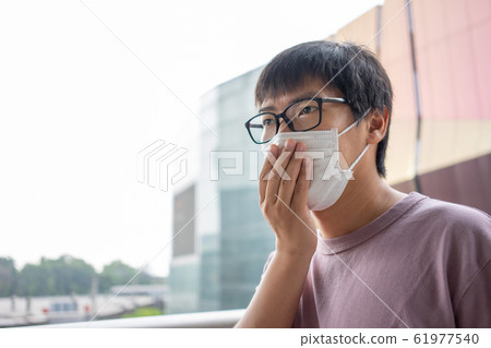HandsomeMan wearing face mask protect filter HandsomeMan wearing face mask protect filter 61977540