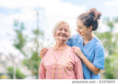 nurse caregiver take care of Asian elderly woman 61978005