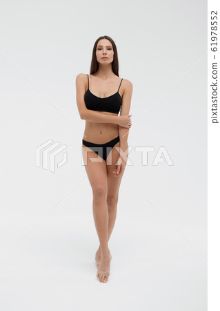 Sexy woman in underwear looking at camera Sexy woman in underwear looking at camera 61978552