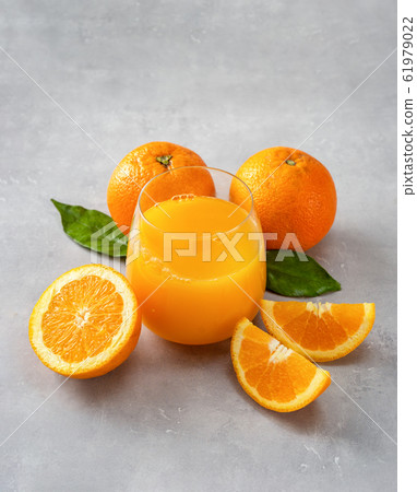 Top view of fresh orange juice, oranges and slices on blue background Top view of fresh orange juice, oranges and slices on blue background 61979022