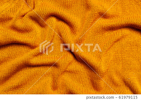 Top view of knitted orange wool fabric Top view of knitted orange wool fabric 61979115