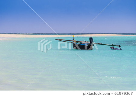Fishermen pirogue moored on turquoise sea of Nosy Ve island, Indian Ocean, Madagascar Fishermen pirogue moored on turquoise sea of Nosy Ve island, Indian Ocean, Madagascar 61979367