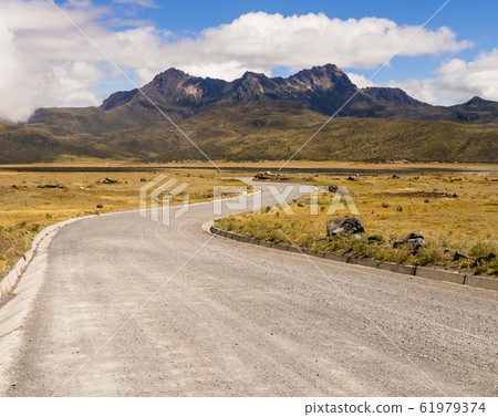 Stunning landscape with winding dirt road leading to Cotopaxi National Park, Ecuador Stunning landscape with winding dirt road leading to Cotopaxi National Park, Ecuador 61979374