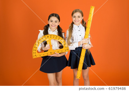 Having a private lesson. Cute schoolgirls holding Having a private lesson. Cute schoolgirls holding 61979486