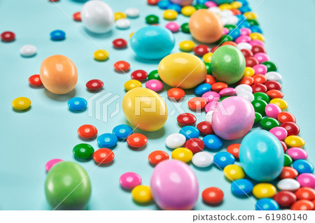 Peanut chocolate balls in colorful sugar shell. 61980140