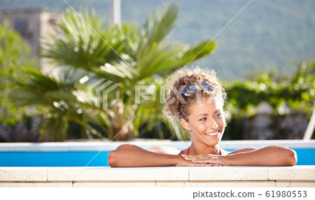 sexy girl in bikini lying near swimming pool. 61980553