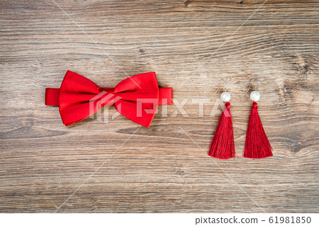 Red bow tie and earings lat lay for 14 February date 61981850