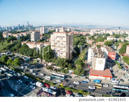 Istanbul cityscape-brown roof houses and modern glass skyscrapers and mosques in the distance Istanbul cityscape-brown roof houses and modern glass skyscrapers and mosques in the distance 61981935