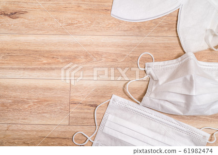 Protective medical mask on wood table background.口罩, 病毒, 傳染病, 生病, 疾病, 武漢肺炎, SARS, 流感, 感冒, 免疫失調 Protective medical mask on wood table background.口罩, 病毒, 傳染病, 生病, 疾病, 武漢肺炎, SARS, 流感, 感冒, 免疫失調 61982474