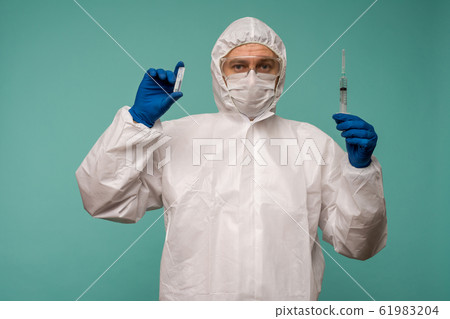 A male doctor in protective overalls and a mask A male doctor in protective overalls and a mask 61983204