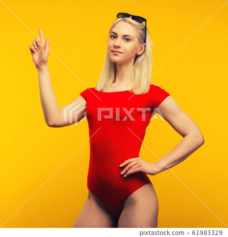 pretty blond lifeguard in red swimsuit and 61983329