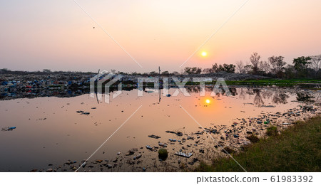 Polluted water and mountain large garbage pile and pollution Polluted water and mountain large garbage pile and pollution 61983392