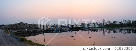 Polluted water and mountain large garbage pile and pollution Polluted water and mountain large garbage pile and pollution 61983396