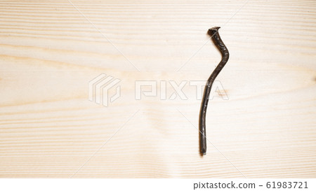 bent nail on a wooden board. Concept stoop, bent nail on a wooden board. Concept stoop, 61983721
