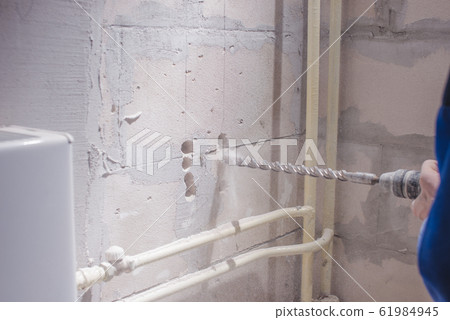 a man working in a white helmet with a large 61984945