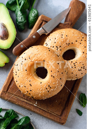 Sesame bagels on wooden board 61985641