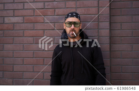 Handsome young unshaven man black hoodie and Handsome young unshaven man black hoodie and 61986548