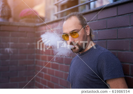 Handsome young unshaven man blue shirt yellow 61986554