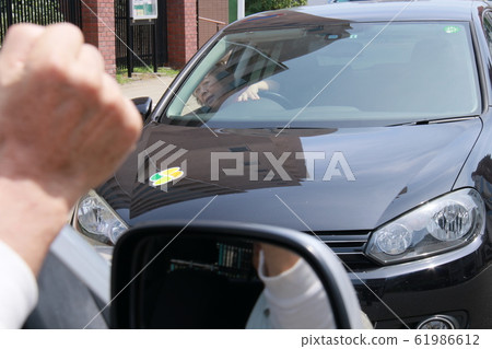 A man angry with a reverse car 61986612