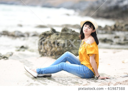 Woman looking at the sea Woman looking at the sea 61987388