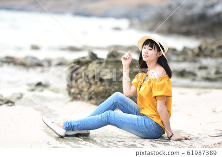 Woman looking at the sea Woman looking at the sea 61987389