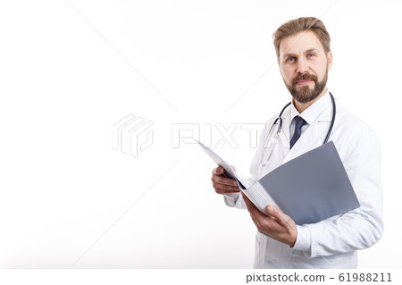 Smiling Bearded Brown-haired Physician Posing With an Open Folder Smiling Bearded Brown-haired Physician Posing With an Open Folder 61988211