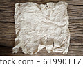 tear crumpled brown paper on wooden 61990117