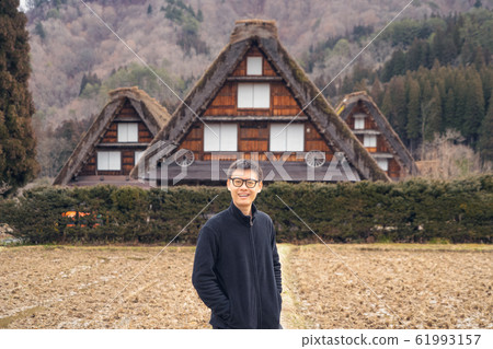 An Asian tourist man at Shirakawago village in 61993157