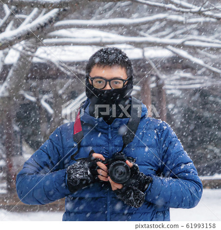 A portrait of Asian photographer holding a camera, A portrait of Asian photographer holding a camera, 61993158