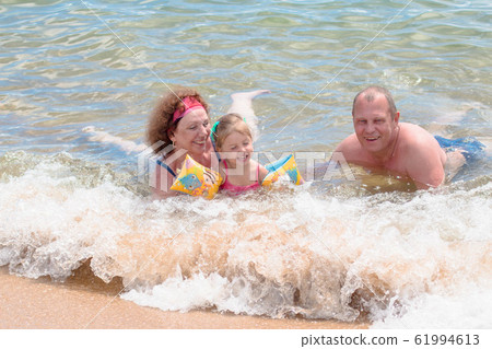 Grandparents And Granddaughter swimming in the Grandparents And Granddaughter swimming in the 61994613