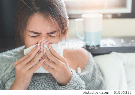 Sick asian woman have hight fever flu and sneezing Sick asian woman have hight fever flu and sneezing 61995352