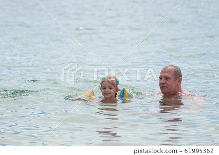 Grandparents And Granddaughter swimming in the Grandparents And Granddaughter swimming in the 61995362