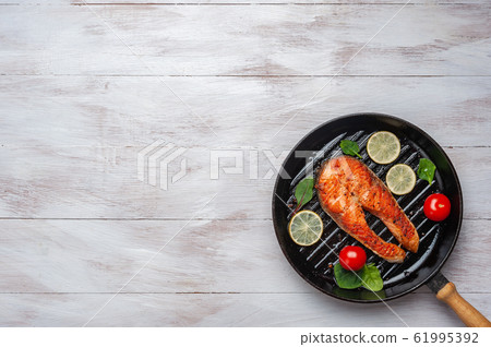 Fried salmon fishes in pan, 61995392