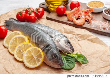 Fresh seabass fishes and shrimps 61995393