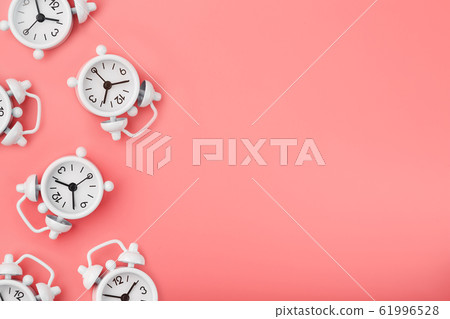 A pattern of many white classic alarm clocks in A pattern of many white classic alarm clocks in 61996528