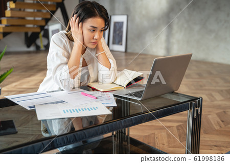 Asian young woman is looking at laptop 61998186
