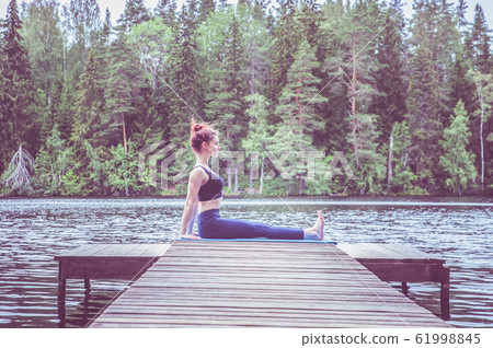 Young yogi  girl  practicing yoga, sitting in 61998845