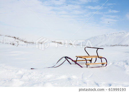 Empty sledge with on the snow on the background of Empty sledge with on the snow on the background of 61999193