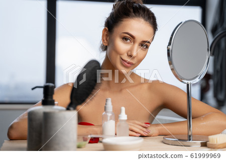 Girl resting her elbows on a dresser 61999969