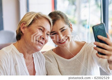 Mother and daughter taking selfie Mother and daughter taking selfie 62002529