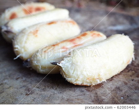Grilled bananas, cut into pieces, prepared on a plate. Grilled bananas, cut into pieces, prepared on a plate. 62003446