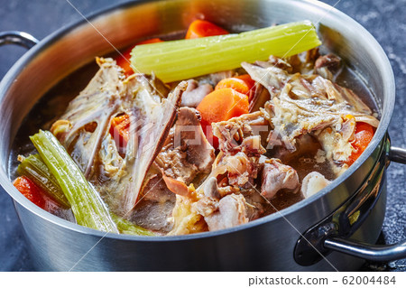 chicken stock in a pot, top view chicken stock in a pot, top view 62004484