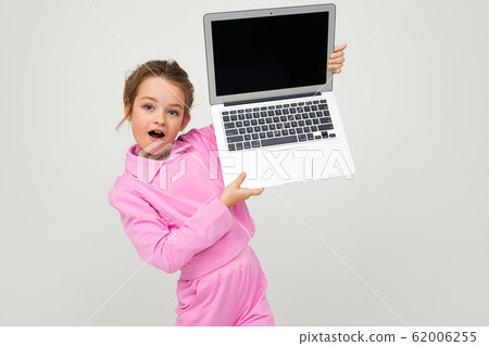 contented caucasian girl holding a laptop with the screen forward with the layout for the page on a contented caucasian girl holding a laptop with the screen forward with the layout for the page on a 62006255