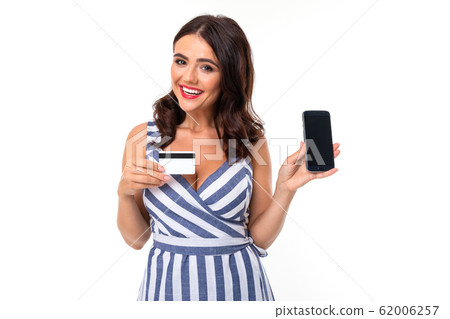 Pretty caucasian woman holds a credit card and mobile phone isolated on white background Pretty caucasian woman holds a credit card and mobile phone isolated on white background 62006257