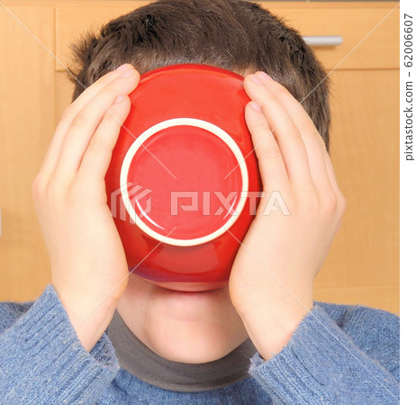 Boy drinking from bowl Boy drinking from bowl 62006607