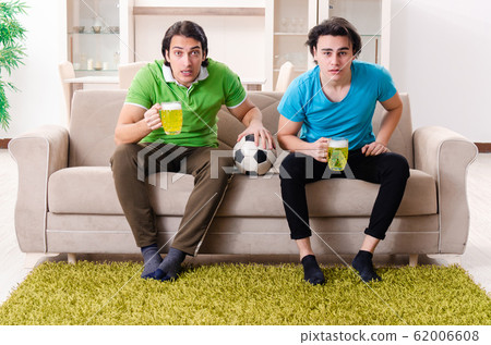 Friends watching football at home Friends watching football at home 62006608