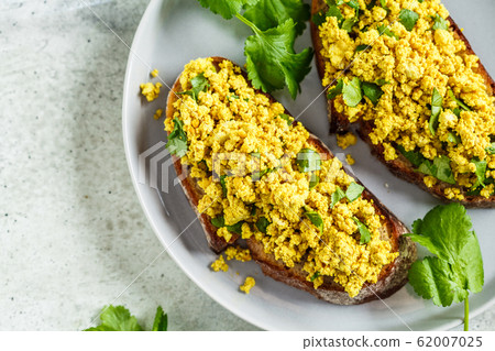 Tofu scramble sandwich on a gray plate. Vegan food Tofu scramble sandwich on a gray plate. Vegan food 62007025