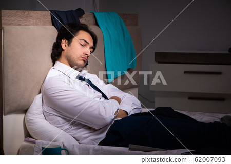 Young employee working at home after night shift Young employee working at home after night shift 62007093