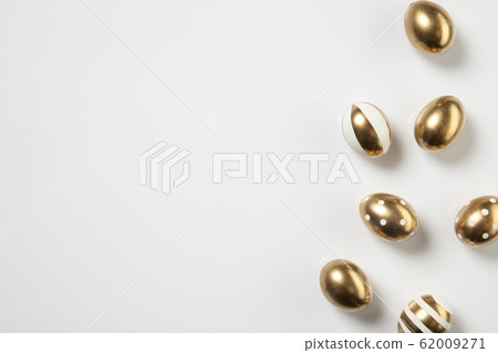 Egg hunt is coming. Easter traditions, golden colored eggs, top view Egg hunt is coming. Easter traditions, golden colored eggs, top view 62009271